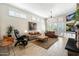 Large living room with hardwood floors, fireplace, and lots of natural light at 6963 E Bramble Berry Ln, Scottsdale, AZ 85266