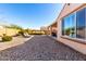 Landscaped backyard with gravel and two lounge chairs at 8088 W Cinder Brook Way, Florence, AZ 85132