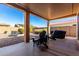 Relaxing covered patio with seating area, and a built-in grill at 8088 W Cinder Brook Way, Florence, AZ 85132