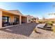 Spacious backyard with gravel, lounge chairs and a covered patio at 8088 W Cinder Brook Way, Florence, AZ 85132