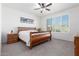 Spacious bedroom with wood bed frame and ceiling fan at 8088 W Cinder Brook Way, Florence, AZ 85132