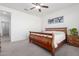 Bright bedroom with wood bed frame and ensuite bathroom at 8088 W Cinder Brook Way, Florence, AZ 85132