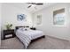 Bright bedroom with a queen bed and window shutters at 8088 W Cinder Brook Way, Florence, AZ 85132