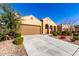 Tan house with brown garage door and nicely landscaped yard at 8088 W Cinder Brook Way, Florence, AZ 85132