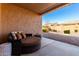 Covered patio with seating area and desert landscaping at 8088 W Cinder Brook Way, Florence, AZ 85132