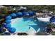 Aerial view of a circular pool with blue umbrellas at 8088 W Cinder Brook Way, Florence, AZ 85132