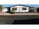 Mobile home with cacti and covered carport at 8600 E Broadway Rd # 43, Mesa, AZ 85208