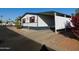 Mobile home with carport and colorful landscaping at 8600 E Broadway Rd # 43, Mesa, AZ 85208