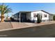 Mobile home with covered carport and desert landscaping at 8600 E Broadway Rd # 43, Mesa, AZ 85208