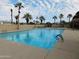 Sparkling community pool with lounge chairs and palm trees at 8600 E Broadway Rd # 43, Mesa, AZ 85208