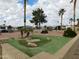 Community putting green with palm trees and landscaping at 8600 E Broadway Rd # 43, Mesa, AZ 85208