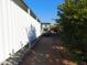 Gravel pathway leads to the home's side entrance, with mature shrubs and a golf cart at 8600 E Broadway Rd # 43, Mesa, AZ 85208