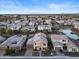 Aerial view of a residential neighborhood with houses and a pond at 904 E Hampton Ln, Gilbert, AZ 85295