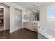 Elegant bathroom with double vanities, a soaking tub, and a walk-in shower at 904 E Hampton Ln, Gilbert, AZ 85295