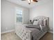 Spacious bedroom with tufted headboard and neutral color palette at 904 E Hampton Ln, Gilbert, AZ 85295