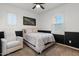 Cozy bedroom with a queen bed, armchair, and two windows with plantation shutters at 904 E Hampton Ln, Gilbert, AZ 85295