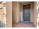 Inviting entryway with a dark brown door and a welcome sign at 904 E Hampton Ln, Gilbert, AZ 85295