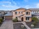 Two-story house with a beige facade, brown roof, and landscaped front yard at 904 E Hampton Ln, Gilbert, AZ 85295