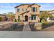 Two-story house with beige exterior, landscaping, and walkway at 904 E Hampton Ln, Gilbert, AZ 85295