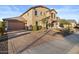 Two-story house with beige exterior and a paved driveway at 904 E Hampton Ln, Gilbert, AZ 85295