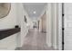 Bright hallway with wood-look flooring and a rustic wood shelf at 904 E Hampton Ln, Gilbert, AZ 85295