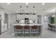 Modern kitchen with white cabinets, large island, and pendant lighting at 904 E Hampton Ln, Gilbert, AZ 85295