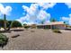 Large backyard with gravel, plants, and home view at 9838 W Santa Fe Dr, Sun City, AZ 85351