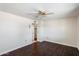 Bright bedroom with wood-look floors and ceiling fan at 9838 W Santa Fe Dr, Sun City, AZ 85351