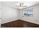 Spacious bedroom featuring wood-look floors and a window at 9838 W Santa Fe Dr, Sun City, AZ 85351