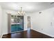 Dining room with dark hardwood floors and view to backyard patio at 9838 W Santa Fe Dr, Sun City, AZ 85351