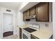 Kitchen with wood cabinets and white appliances at 9838 W Santa Fe Dr, Sun City, AZ 85351