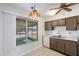 Kitchen with wood cabinets and a view to the backyard at 9838 W Santa Fe Dr, Sun City, AZ 85351