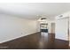 Bright living room featuring dark hardwood floors and a sliding glass door at 9838 W Santa Fe Dr, Sun City, AZ 85351