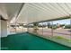 Relaxing screened porch with green carpet flooring at 9838 W Santa Fe Dr, Sun City, AZ 85351