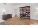 Bedroom with built-in bookcase and hardwood floors at 10418 N Central Ave, Phoenix, AZ 85020