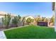 Landscaped backyard with artificial turf and hot tub at 10488 W Deanna Dr, Peoria, AZ 85382