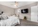 Spacious bedroom with large TV and ensuite bathroom at 10488 W Deanna Dr, Peoria, AZ 85382