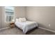 Bright bedroom with window and bedside table at 10488 W Deanna Dr, Peoria, AZ 85382