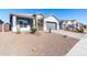 Single-story home with gray exterior, two-car garage, and desert landscaping at 10488 W Deanna Dr, Peoria, AZ 85382