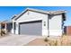 Single-story home with gray exterior, two-car garage, and desert landscaping at 10488 W Deanna Dr, Peoria, AZ 85382