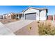 Single-story home with gray exterior, two-car garage, and desert landscaping at 10488 W Deanna Dr, Peoria, AZ 85382