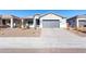 Single-story home with gray exterior, two-car garage, and desert landscaping at 10488 W Deanna Dr, Peoria, AZ 85382
