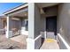 Covered front porch with yellow welcome mat and gray door at 10488 W Deanna Dr, Peoria, AZ 85382