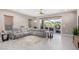 Spacious living room with gray sectional sofa and large windows at 10488 W Deanna Dr, Peoria, AZ 85382