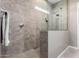 Walk-in shower with neutral tile and glass enclosure at 10488 W Deanna Dr, Peoria, AZ 85382