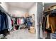 Large walk-in closet with ample hanging space and shelving at 10488 W Deanna Dr, Peoria, AZ 85382