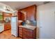 Functional kitchen area featuring ample wood cabinets, tile backsplash, and a modern refrigerator at 10814 W Palmeras Dr, Sun City, AZ 85373