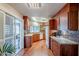 An open kitchen features wood floors, cabinets, and a mosaic tile backsplash at 10814 W Palmeras Dr, Sun City, AZ 85373