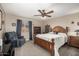 Bedroom with king-size bed, ceiling fan, and recliner at 11249 E Stradling Ave, Mesa, AZ 85212