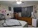 Bedroom with dresser, TV, and star ceiling at 11548 E Wier Ave, Mesa, AZ 85208